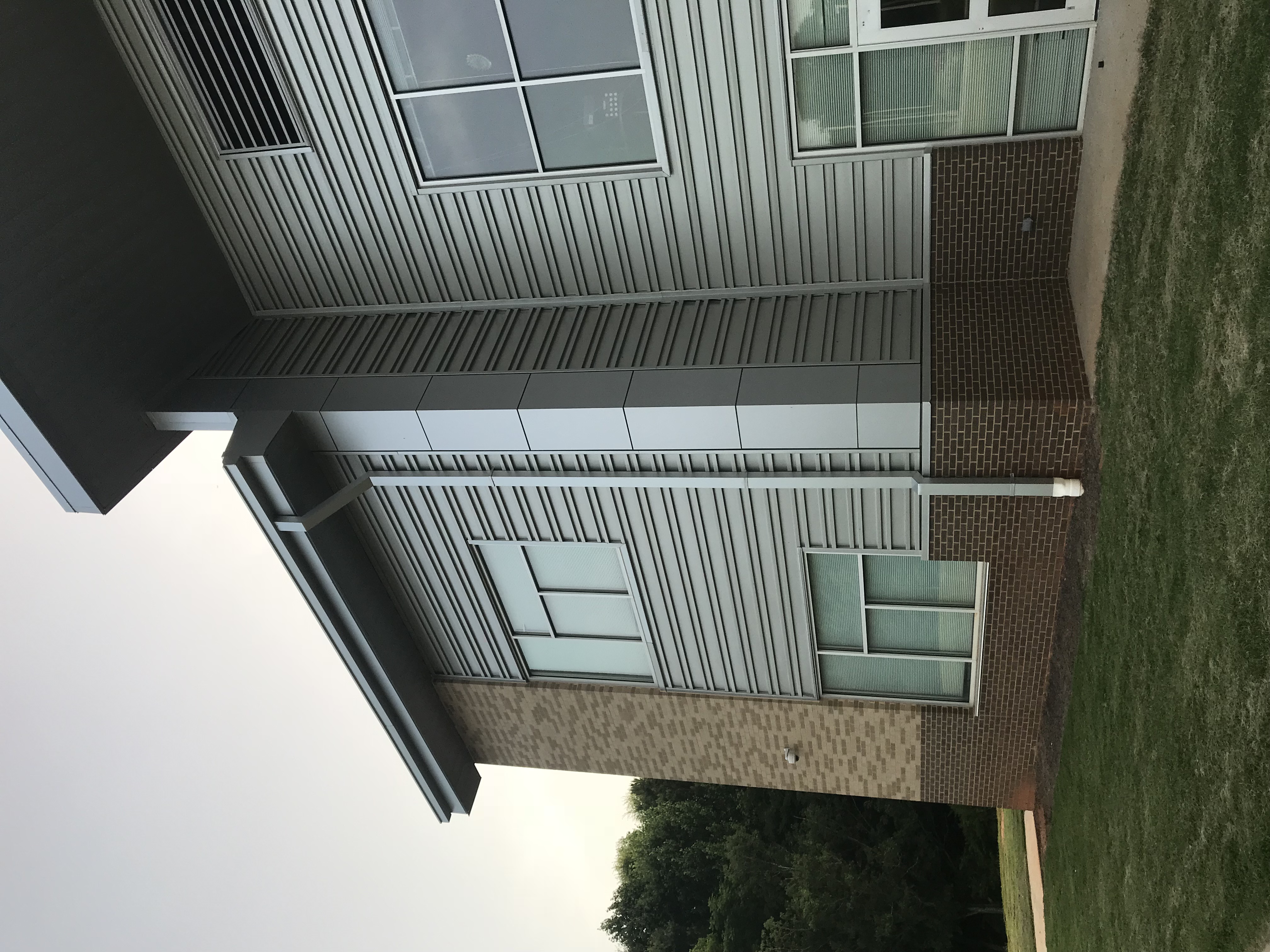 Gutter and downspout at a building roof edge