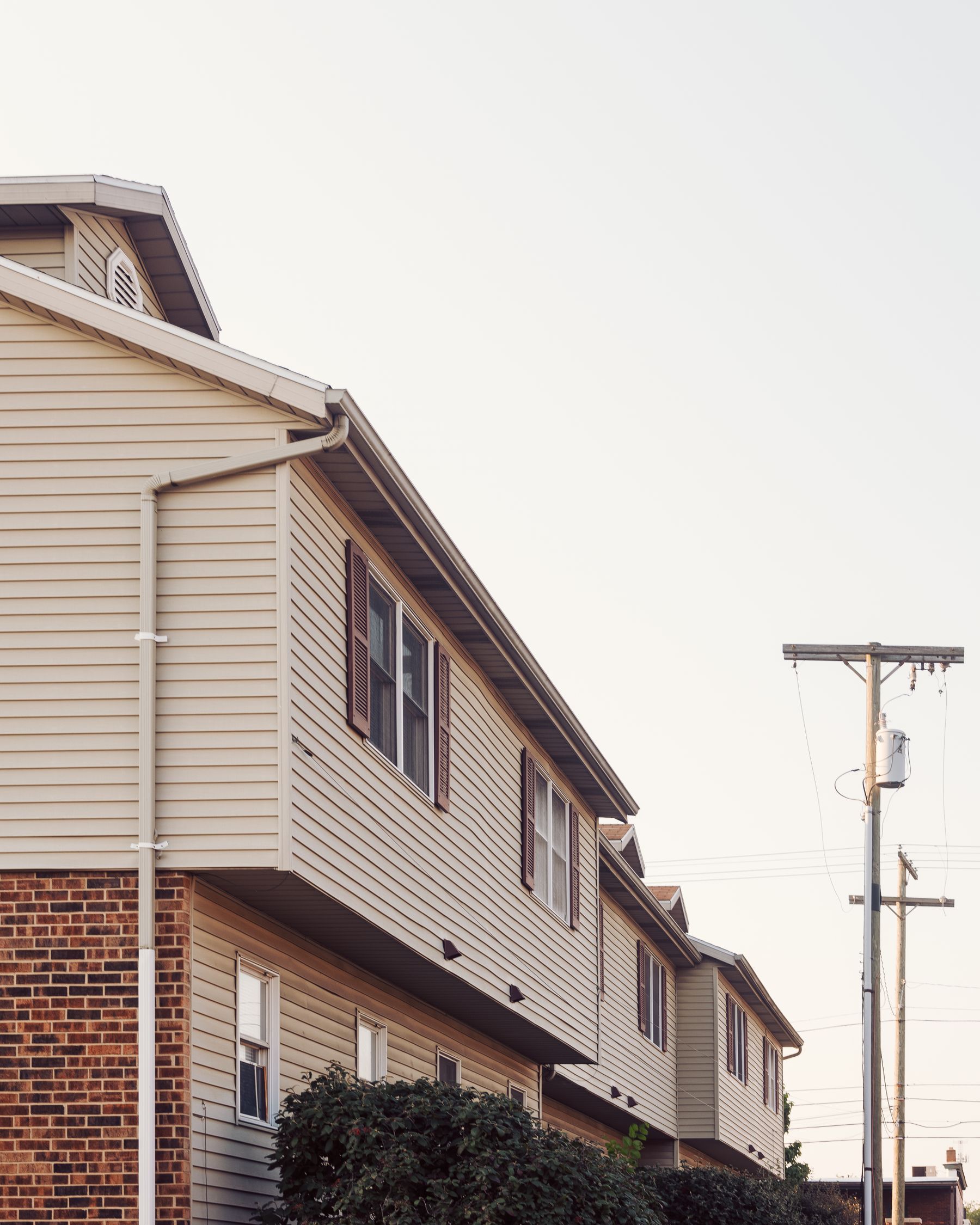 Horizontal siding, window trim and brick on residential homes