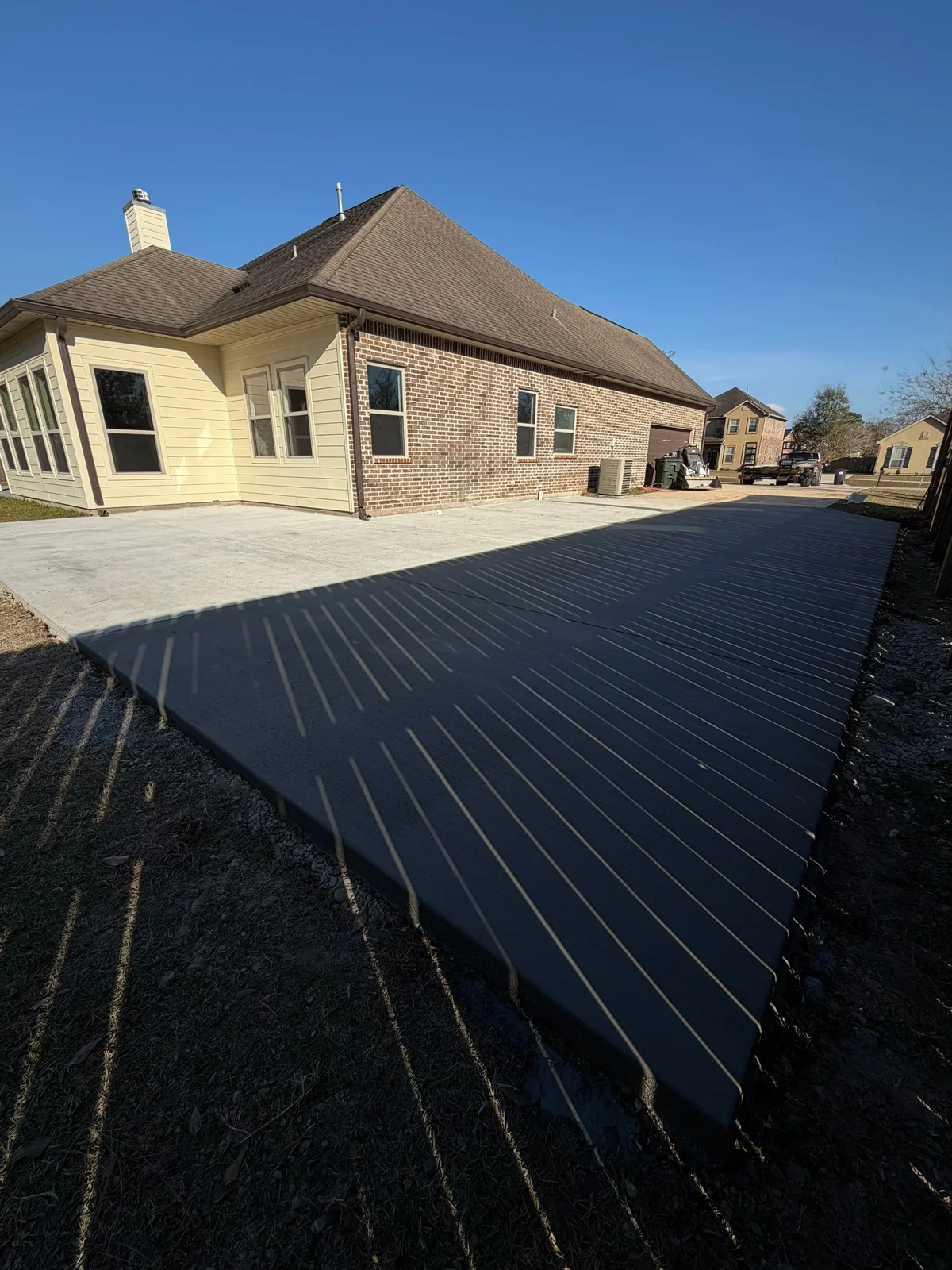 Completed SCS residential concrete addition beside a home in Madisonville