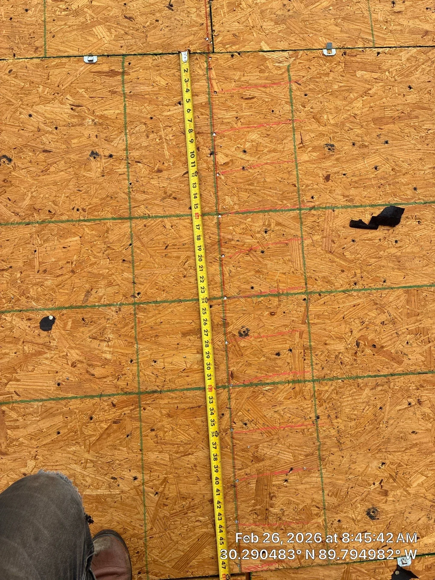 Exposed roof decking with a tape measure beside the fasteners